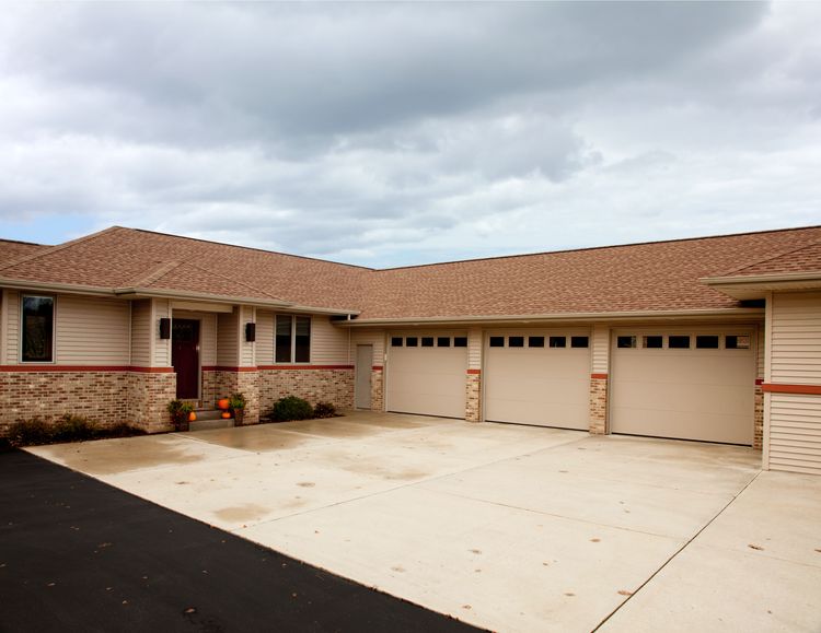 Almond-tinted steel raised panel garage door