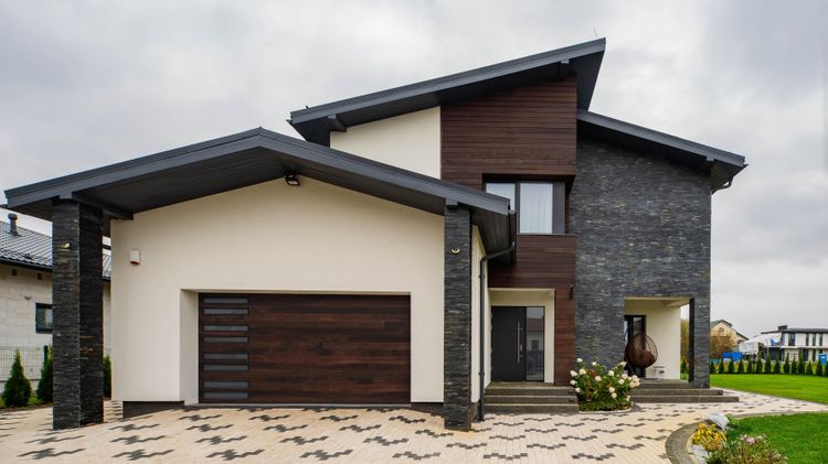 Modern house with plank flush modern garage door in walnut with side windows