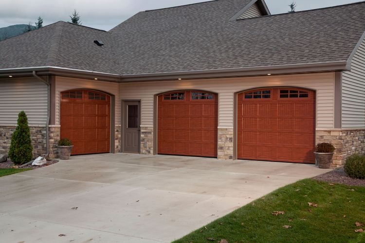 Cherry raised panel garage doors with windows.