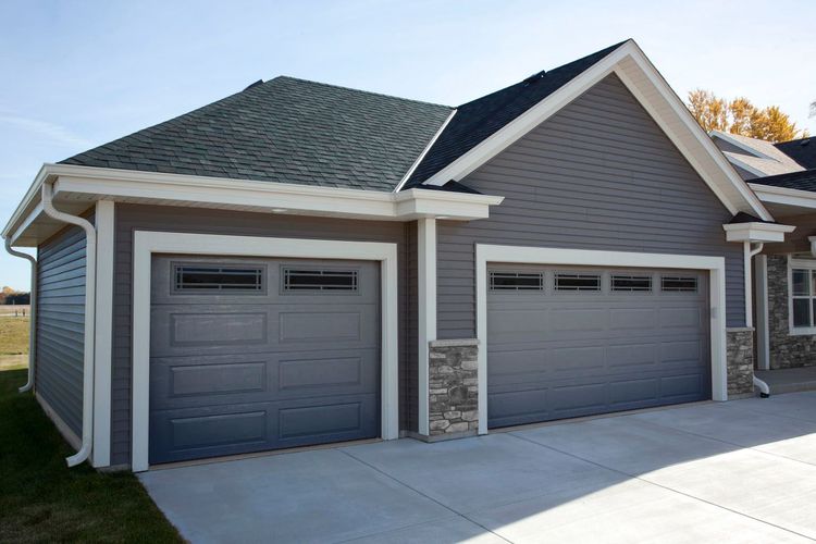 Charcoal raised panel garage doors with thin top windows