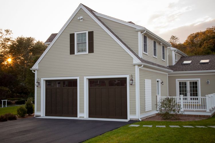 Raised panel espresso garage door with windows.