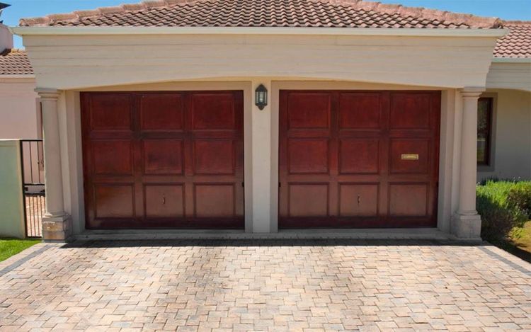 House with 2 single-car garage doors with raised panels