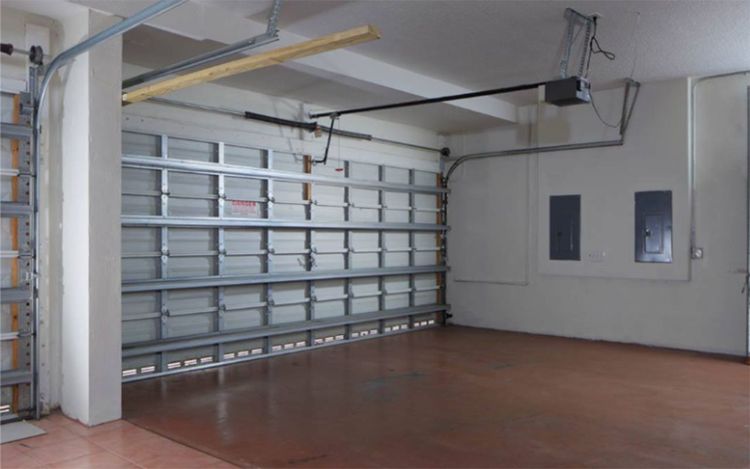 Interior view of a garage with a professionally installed garage door.